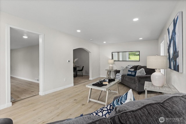 8661 State Highway 303 NE, Bremerton, WA 98311 - living room featuring recessed lighting, arched walkways, and wood finished floors