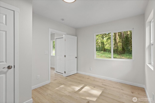 8661 State Highway 303 NE, Bremerton, WA 98311 - unfurnished bedroom with baseboards and light wood-style flooring