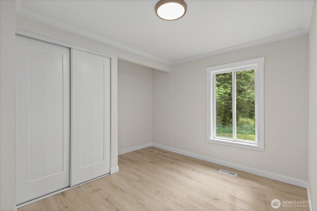 8661 State Highway 303 NE, Bremerton, WA 98311 - unfurnished bedroom with visible vents, crown molding, baseboards, a closet, and light wood-style floors