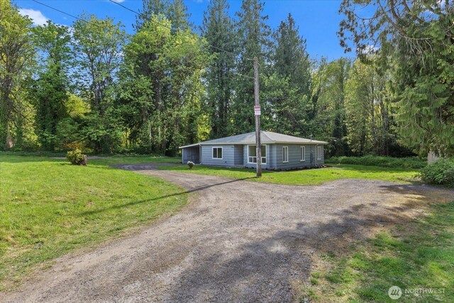 8661 State Highway 303 NE, Bremerton, WA 98311 - ranch-style home with a front lawn, driveway, and a forest view