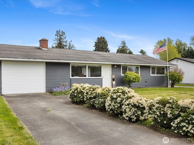 single story home featuring a garage, driveway, and a chimney