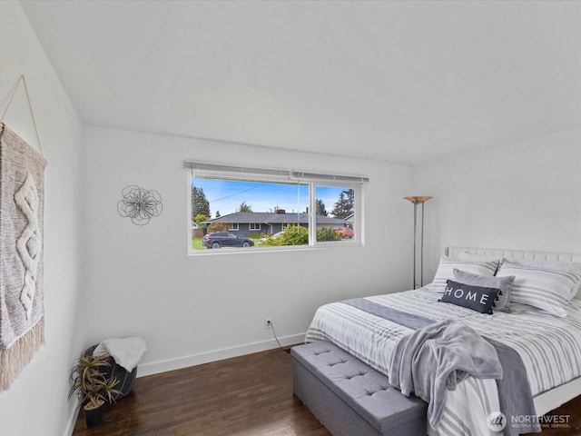 bedroom featuring baseboards and wood finished floors