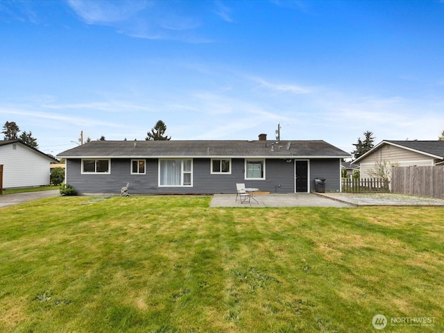 back of house with fence, a lawn, and a patio area