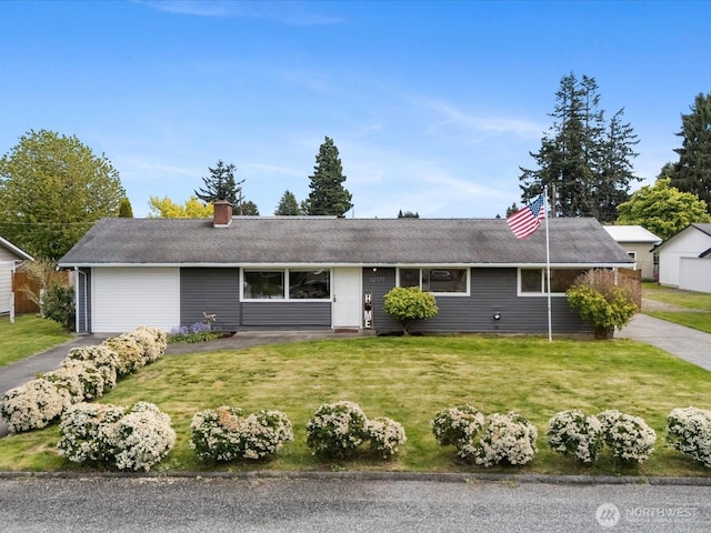 single story home with a garage, a chimney, a front lawn, and aphalt driveway