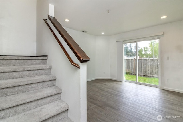 stairs with visible vents, recessed lighting, baseboards, and wood finished floors