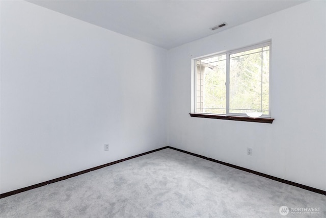 carpeted empty room with baseboards and visible vents