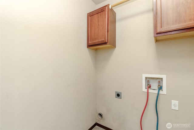 washroom with baseboards, hookup for an electric dryer, hookup for a washing machine, and cabinet space