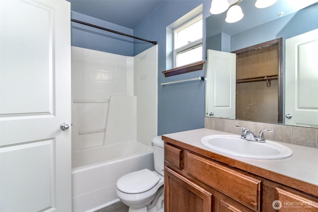 bathroom with toilet, bathing tub / shower combination, and vanity