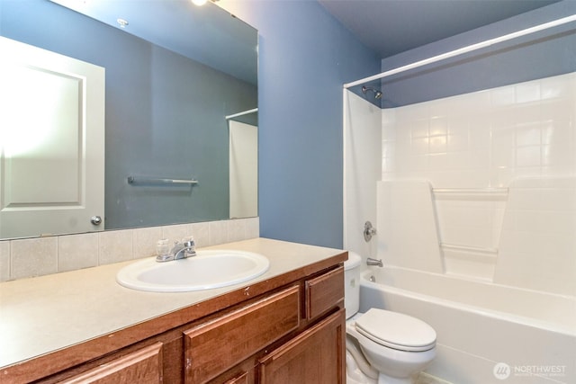 bathroom with toilet, washtub / shower combination, and vanity