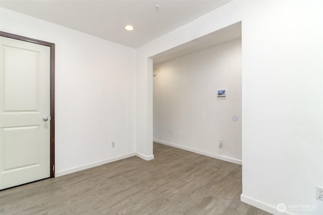 unfurnished room featuring light wood-style floors, baseboards, and recessed lighting