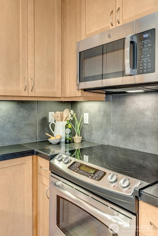 kitchen featuring light brown cabinets, decorative backsplash, and appliances with stainless steel finishes