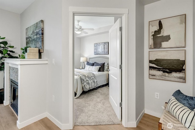 hallway featuring baseboards and light wood-style floors