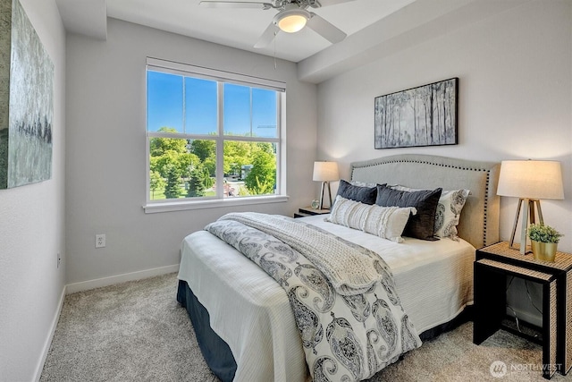 carpeted bedroom featuring baseboards and ceiling fan