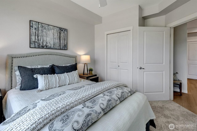 bedroom featuring a ceiling fan, a closet, and wood finished floors