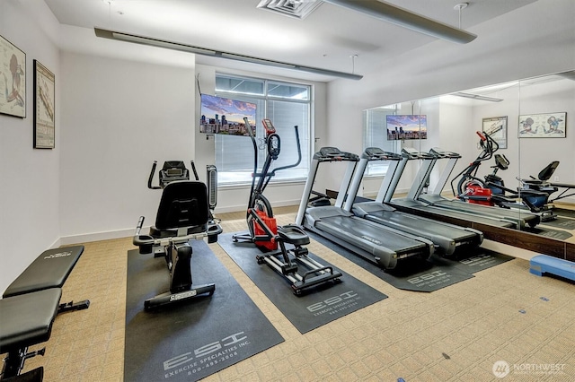 exercise room featuring carpet floors, baseboards, and visible vents