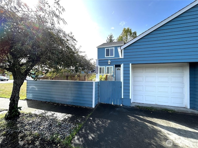 19573 2nd Ave NE, Poulsbo, WA 98366 - view of property exterior featuring a garage and asphalt driveway