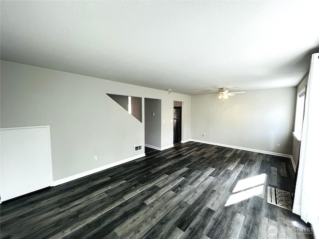 19573 2nd Ave NE, Poulsbo, WA 98366 - unfurnished room featuring a ceiling fan, dark wood-style flooring, baseboards, and a textured ceiling