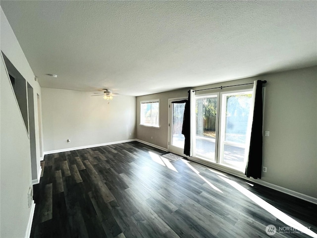 19573 2nd Ave NE, Poulsbo, WA 98366 - spare room with dark wood-style floors, a ceiling fan, a textured ceiling, and baseboards