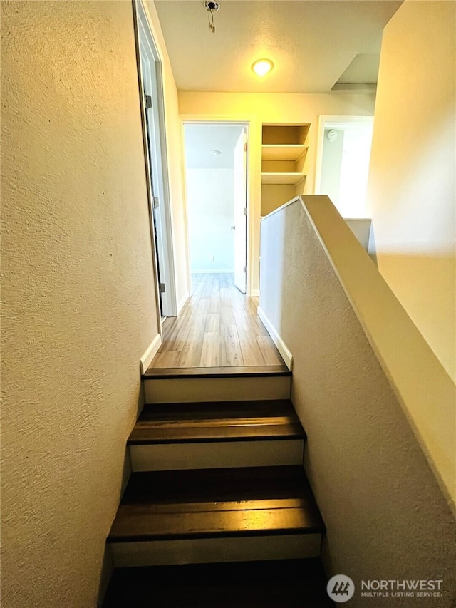 19573 2nd Ave NE, Poulsbo, WA 98366 - stairway with a textured wall, built in features, and wood finished floors