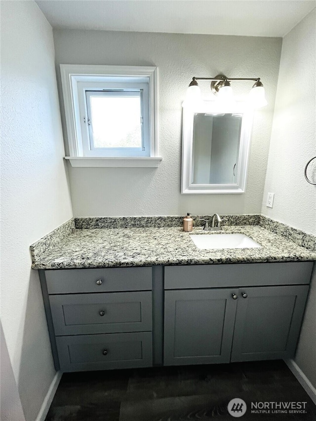 19573 2nd Ave NE, Poulsbo, WA 98366 - bathroom featuring vanity, wood finished floors, and baseboards