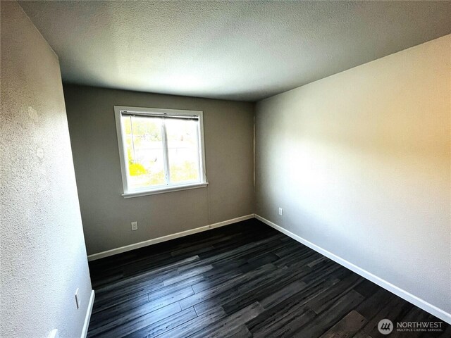 19573 2nd Ave NE, Poulsbo, WA 98366 - spare room with dark wood-style floors and baseboards
