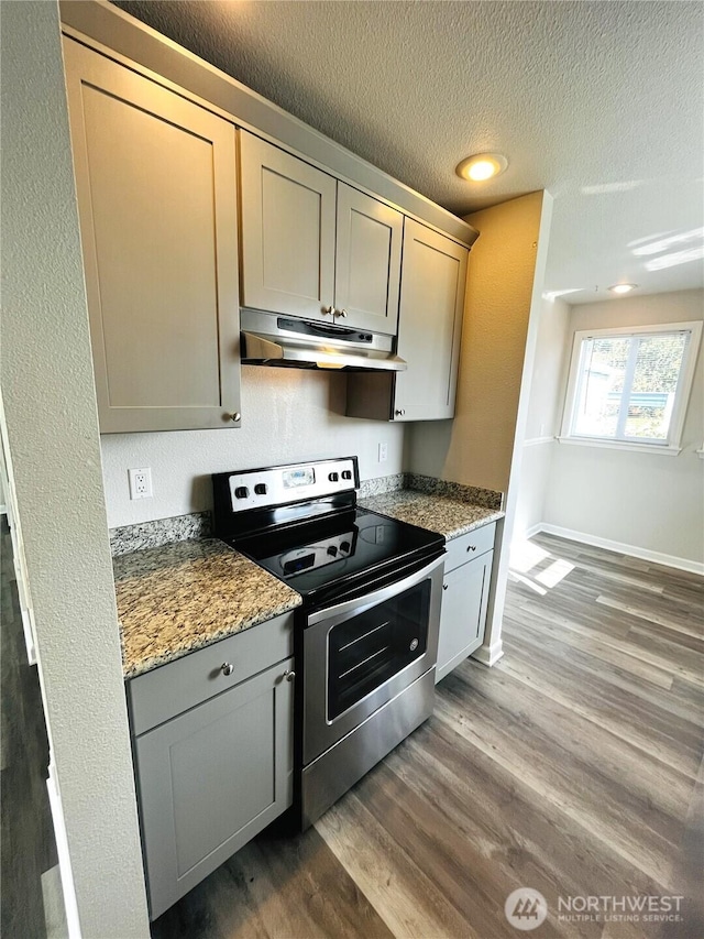 19573 2nd Ave NE, Poulsbo, WA 98366 - kitchen featuring under cabinet range hood, stainless steel electric range, dark wood-style flooring, a textured ceiling, and gray cabinetry