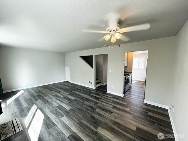 19573 2nd Ave NE, Poulsbo, WA 98366 - unfurnished living room with a ceiling fan, dark wood finished floors, baseboards, and a textured ceiling