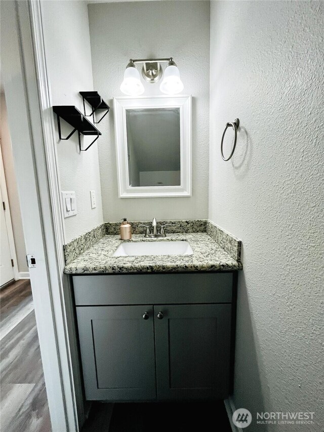 19573 2nd Ave NE, Poulsbo, WA 98366 - bathroom featuring vanity, a textured wall, and wood finished floors
