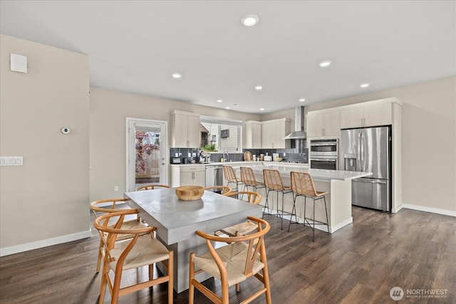 dining room featuring recessed lighting, dark wood finished floors, and baseboards