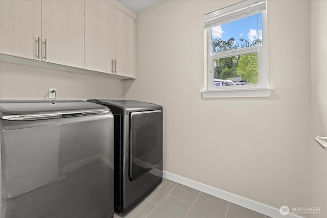 laundry room featuring baseboards, cabinet space, independent washer and dryer, and tile patterned floors