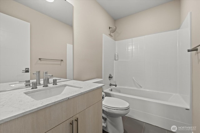 bathroom featuring vanity, toilet, tile patterned floors, and bathtub / shower combination
