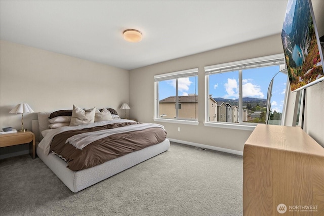 carpeted bedroom featuring baseboards