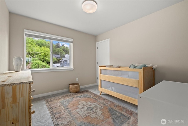 carpeted bedroom featuring baseboards