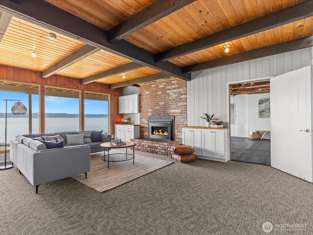 2690 SW 151st Pl, Burien, WA 98166 - carpeted living room with wood ceiling, a brick fireplace, wood walls, beamed ceiling, and a water view