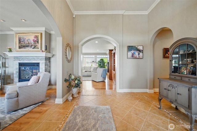 2961 Kendall Rd, Walla Walla, WA 99362 - living room featuring light tile patterned flooring, arched walkways, crown molding, a fireplace, and baseboards