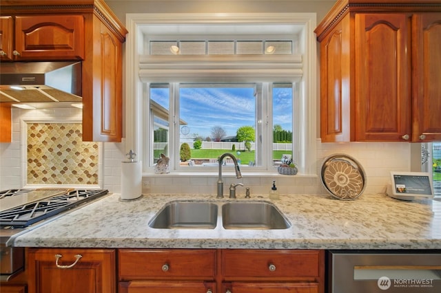 2961 Kendall Rd, Walla Walla, WA 99362 - kitchen featuring a sink, appliances with stainless steel finishes, light stone counters, backsplash, and wall chimney range hood