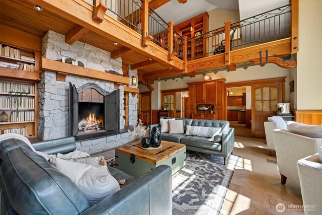 2141 Northshore Rd, Bellingham, WA 98226 - living room featuring wood ceiling, a fireplace, beam ceiling, a wainscoted wall, and a high ceiling
