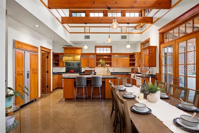 2141 Northshore Rd, Bellingham, WA 98226 - kitchen with visible vents, a towering ceiling, a center island, open shelves, and paneled built in fridge