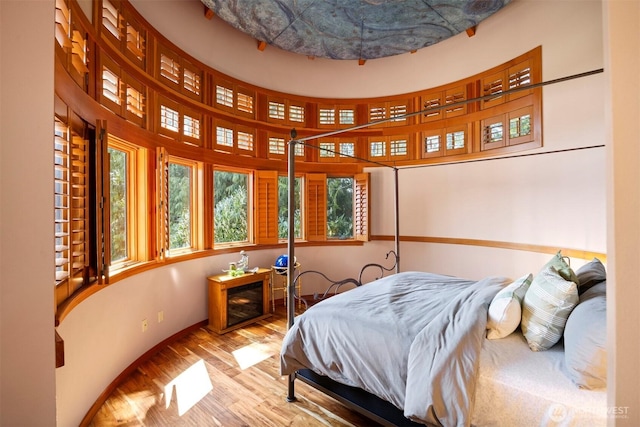 2141 Northshore Rd, Bellingham, WA 98226 - bedroom featuring baseboards, multiple windows, wood finished floors, and a high ceiling
