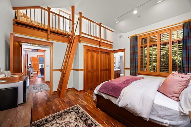 2141 Northshore Rd, Bellingham, WA 98226 - bedroom with track lighting, a high ceiling, visible vents, and wood finished floors