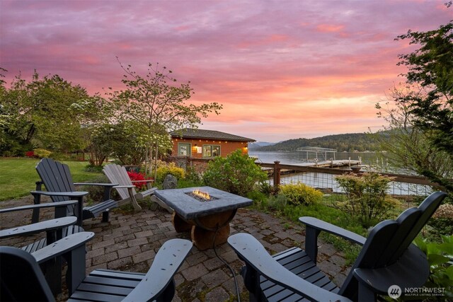 2141 Northshore Rd, Bellingham, WA 98226 - patio terrace at dusk featuring a water view, a dock, and an outdoor fire pit