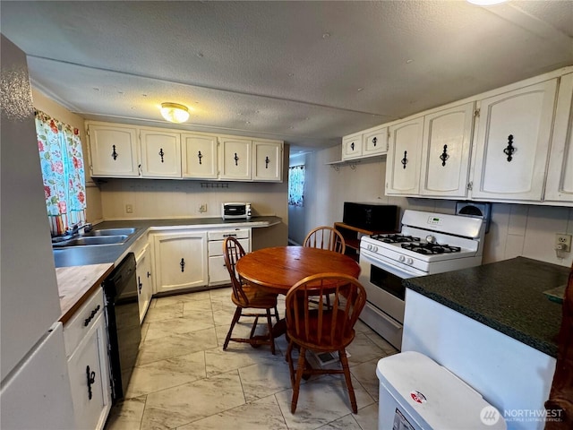 kitchen featuring white appliances, white cabinetry, a sink, and marble finish floor