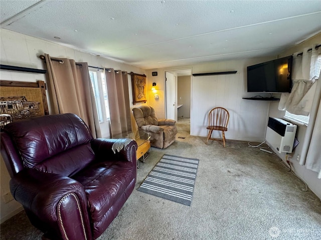 living room with carpet flooring, a textured ceiling, and heating unit