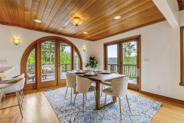 dining area with french doors, wood ceiling, crown molding, and light wood-type flooring