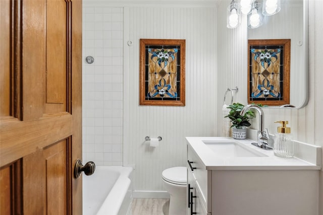 bathroom featuring crown molding, vanity, baseboards, and toilet