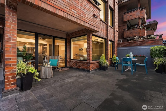 2320 43rd Ave E Unit 15A, Seattle, WA 98112 - patio terrace at dusk with outdoor dining area