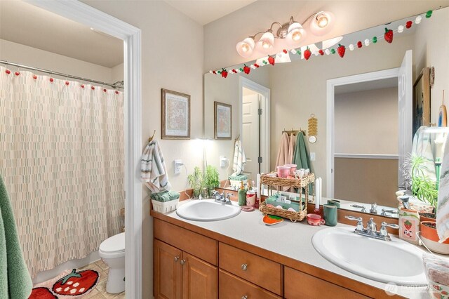 bathroom featuring tile patterned flooring, a sink, double vanity, and toilet