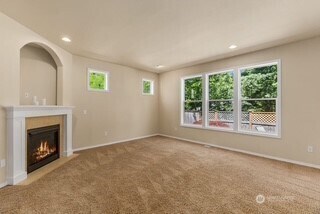 4504 5th Ave NW, Olympia, WA 98502 - unfurnished living room featuring a glass covered fireplace, carpet, and recessed lighting