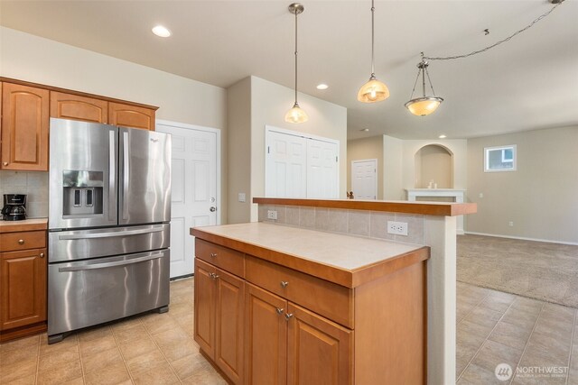 4504 5th Ave NW, Olympia, WA 98502 - kitchen featuring stainless steel refrigerator with ice dispenser, light countertops, recessed lighting, brown cabinetry, and backsplash