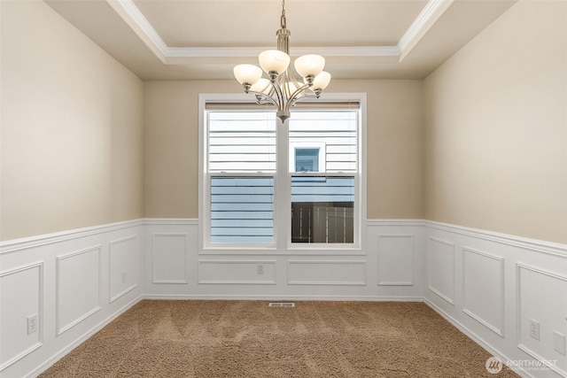 4504 5th Ave NW, Olympia, WA 98502 - carpeted spare room with a tray ceiling, a chandelier, ornamental molding, wainscoting, and a decorative wall
